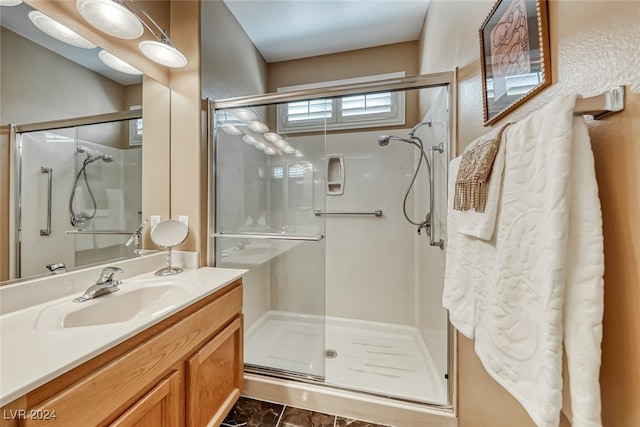 bathroom featuring vanity and a shower with door