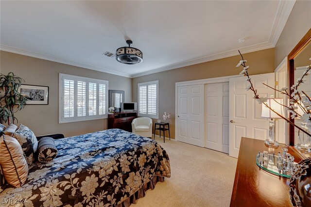 bedroom with light colored carpet, a closet, and ornamental molding