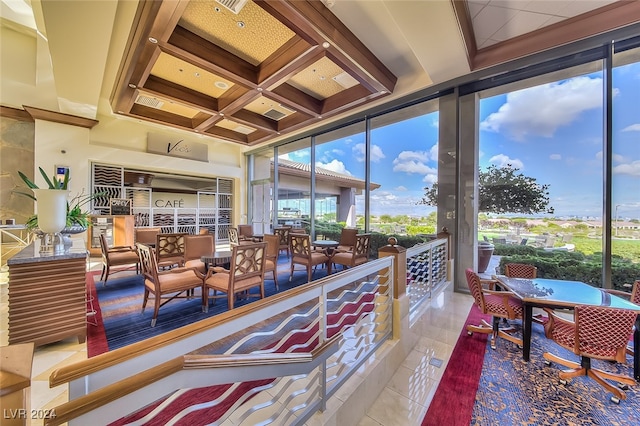 sunroom featuring beam ceiling and coffered ceiling