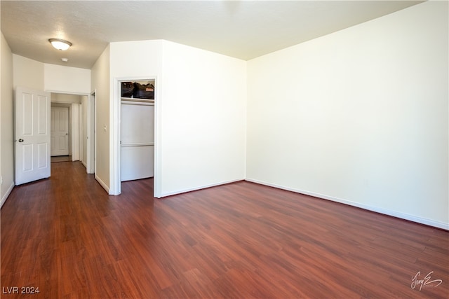 unfurnished bedroom with a closet, dark wood-type flooring, and a textured ceiling