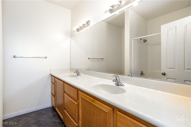 bathroom featuring tile patterned flooring, vanity, and walk in shower