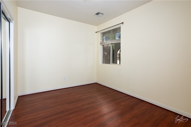 unfurnished room with dark hardwood / wood-style floors