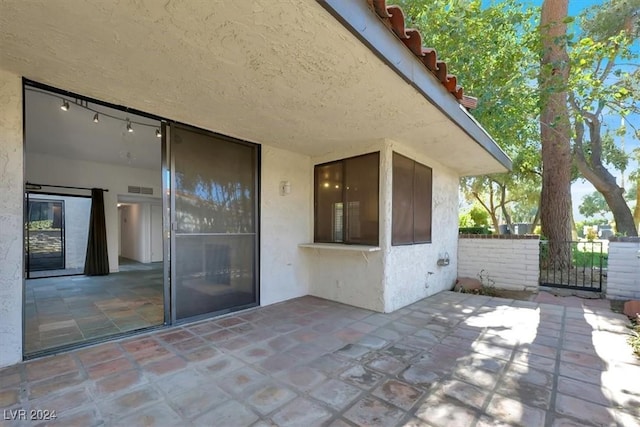 view of patio featuring visible vents and fence