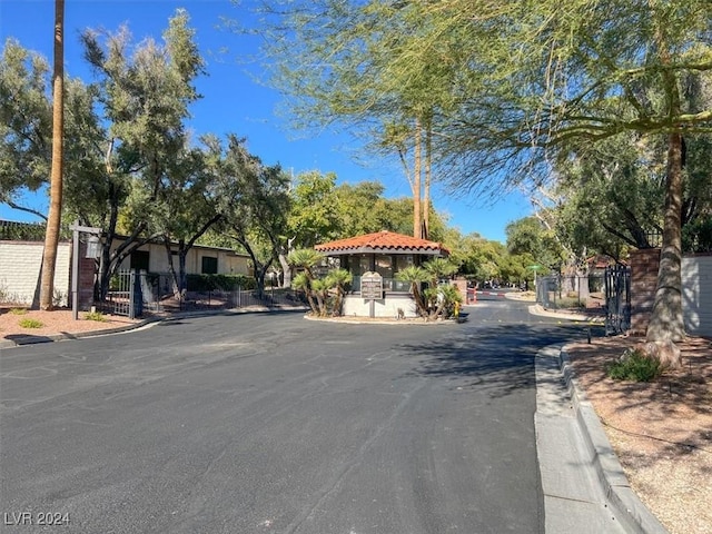 view of street featuring curbs and a gated entry