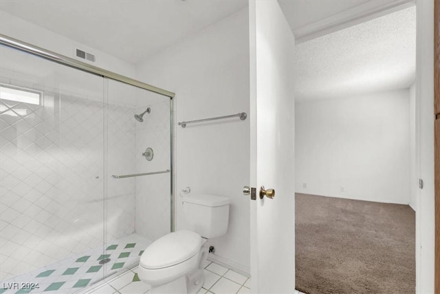 bathroom with toilet, a stall shower, a textured ceiling, and visible vents