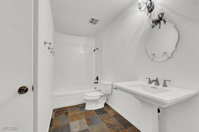 full bathroom featuring stone finish floor, shower / bath combination, visible vents, and toilet