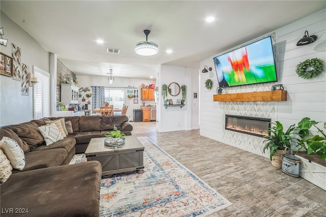 living room featuring hardwood / wood-style floors and a stone fireplace