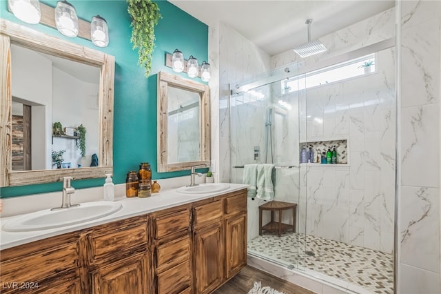 bathroom with hardwood / wood-style floors, vanity, and an enclosed shower