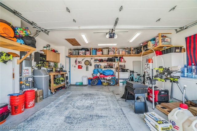 garage with a workshop area and a garage door opener