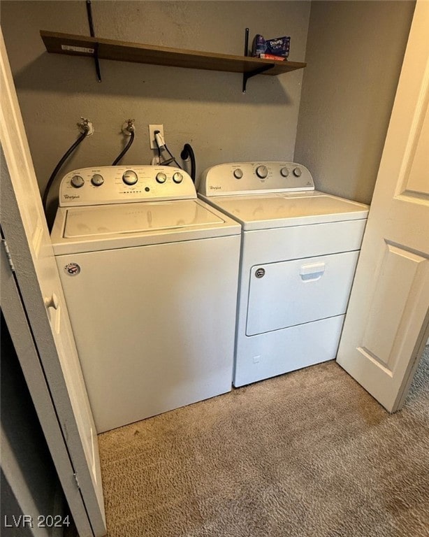 clothes washing area featuring washer and dryer and light colored carpet