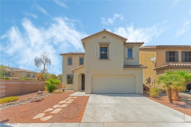 mediterranean / spanish home featuring a garage