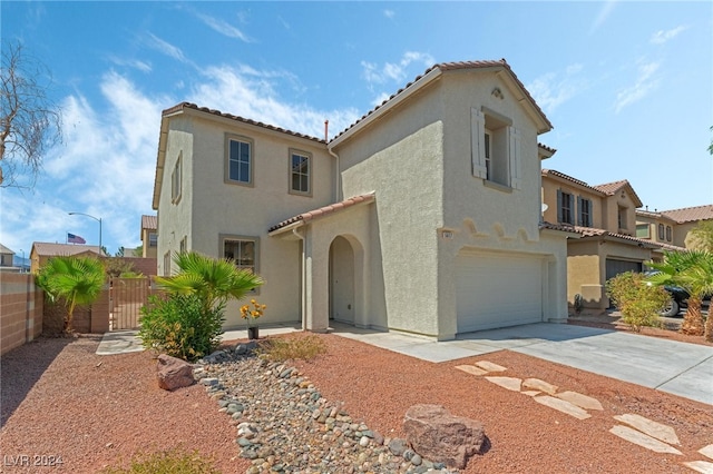 mediterranean / spanish-style home with a garage