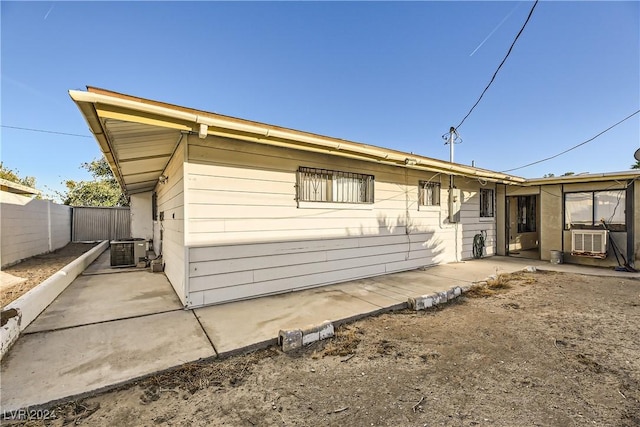 rear view of house featuring cooling unit