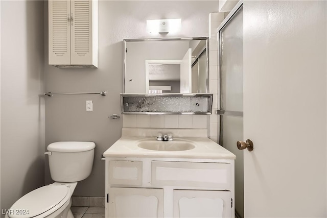 bathroom with tile patterned floors, vanity, tasteful backsplash, and toilet