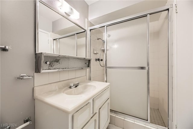 bathroom with vanity and a shower with shower door