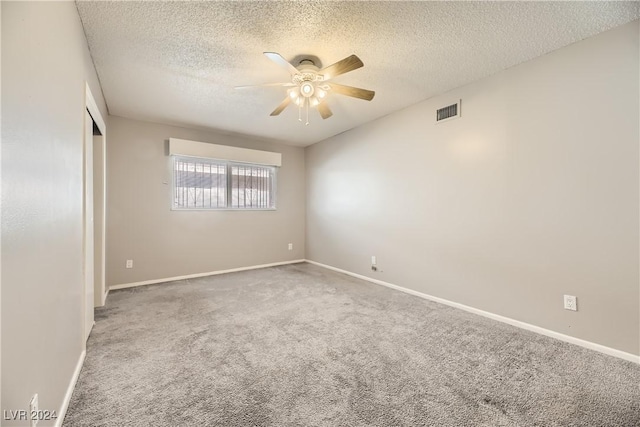 empty room with carpet, a textured ceiling, and ceiling fan