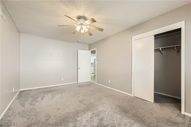 unfurnished bedroom with carpet flooring, ceiling fan, a closet, and a textured ceiling