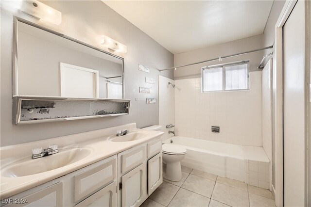 full bathroom featuring tile patterned flooring, vanity, toilet, and tiled shower / bath