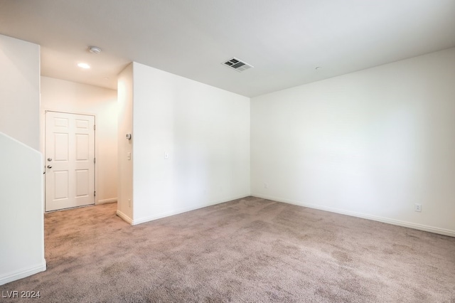 empty room featuring light carpet