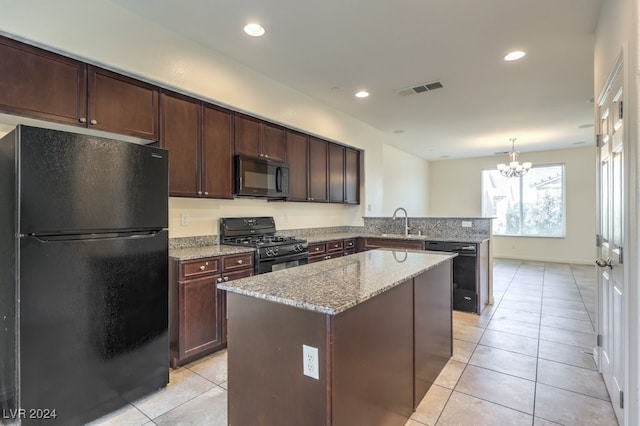 kitchen with kitchen peninsula, a kitchen island, black appliances, and an inviting chandelier