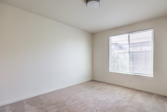 unfurnished room with light carpet