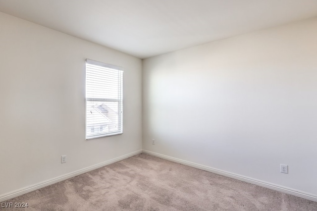 unfurnished room featuring light colored carpet