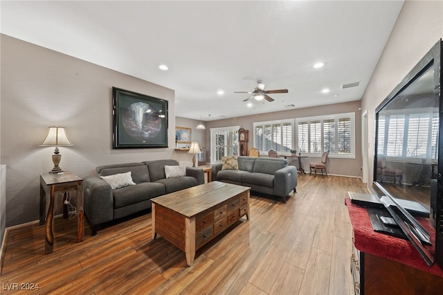 living room with hardwood / wood-style flooring and ceiling fan