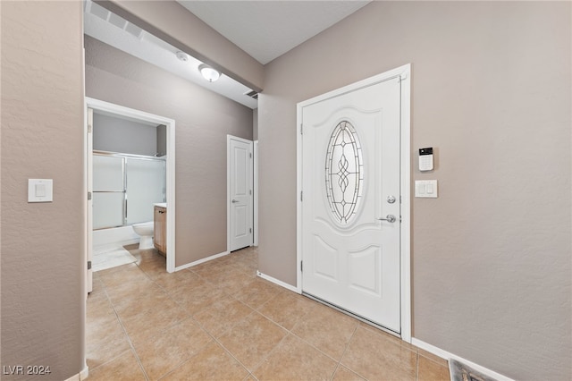 foyer entrance featuring light tile patterned floors