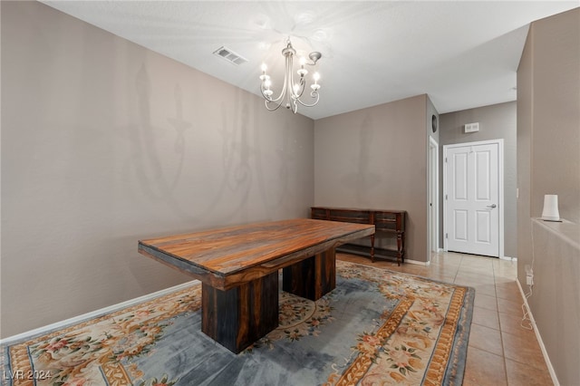 dining room featuring light tile patterned floors and a notable chandelier