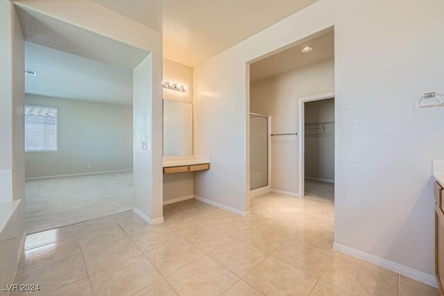 62 Augusta Course Ave, Las Vegas, NV 89148 - bathroom with vanity, a stall shower, a spacious closet, and tile patterned floors