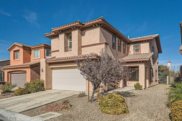 62 Augusta Course Ave, Las Vegas, NV 89148 - view of front of home featuring a tiled roof, an attached garage, stucco siding, and concrete driveway