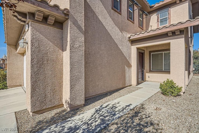 62 Augusta Course Ave, Las Vegas, NV 89148 - doorway to property featuring a tile roof and stucco siding