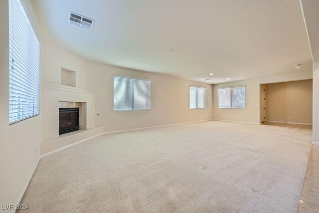 62 Augusta Course Ave, Las Vegas, NV 89148 - unfurnished living room featuring a fireplace and light carpet