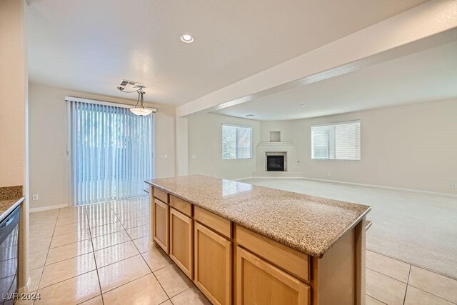 62 Augusta Course Ave, Las Vegas, NV 89148 - kitchen with light tile patterned flooring, a kitchen island, open floor plan, light colored carpet, and pendant lighting