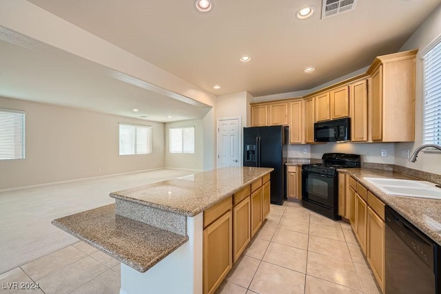 62 Augusta Course Ave, Las Vegas, NV 89148 - kitchen featuring black appliances, light carpet, a center island, light tile patterned flooring, and recessed lighting