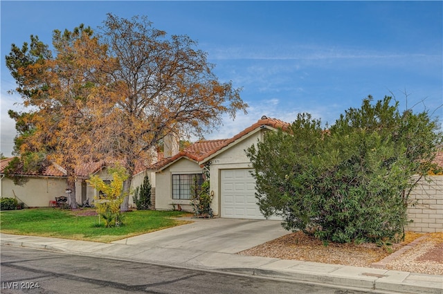 view of front of property with a front yard and a garage