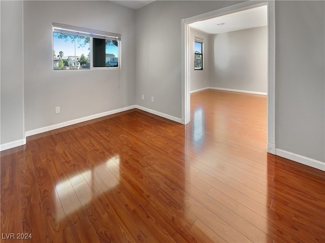 unfurnished room with hardwood / wood-style flooring