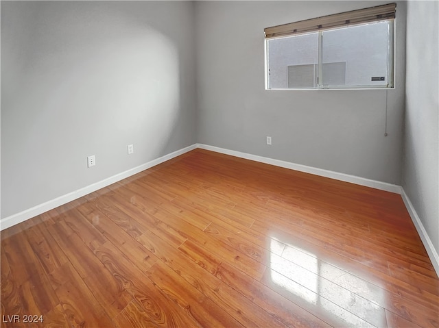 empty room with hardwood / wood-style floors