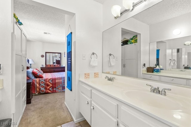 bathroom featuring vanity and a textured ceiling