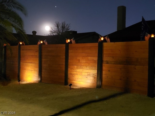 view of gate at night