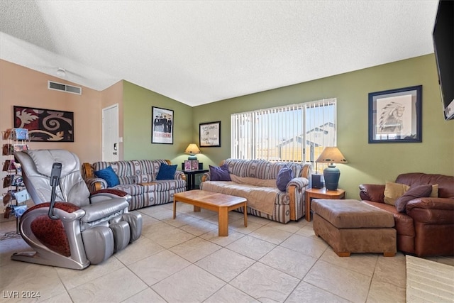 living room with light tile patterned flooring, lofted ceiling, and a textured ceiling