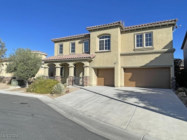 mediterranean / spanish house featuring a garage