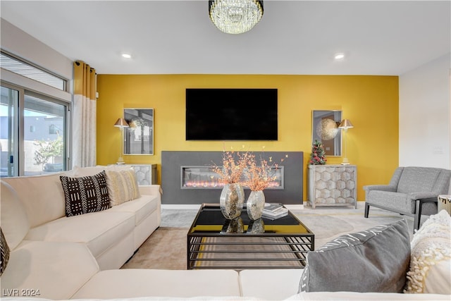 carpeted living room featuring a chandelier