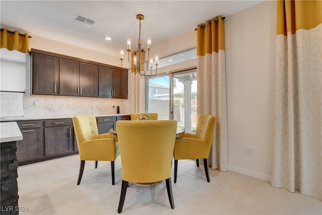 tiled dining area with a chandelier