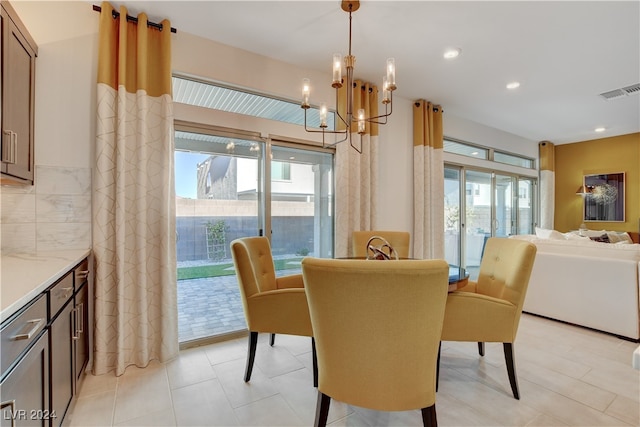 dining room with light tile patterned flooring and an inviting chandelier