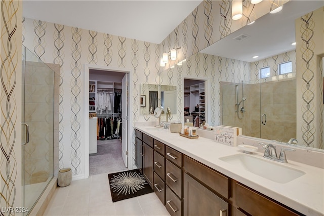 bathroom with tile patterned floors, a shower with door, and vanity