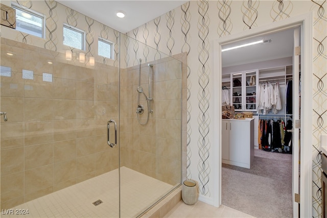 bathroom with tile patterned flooring and a shower with shower door