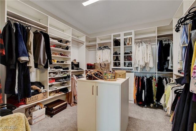 walk in closet featuring light colored carpet