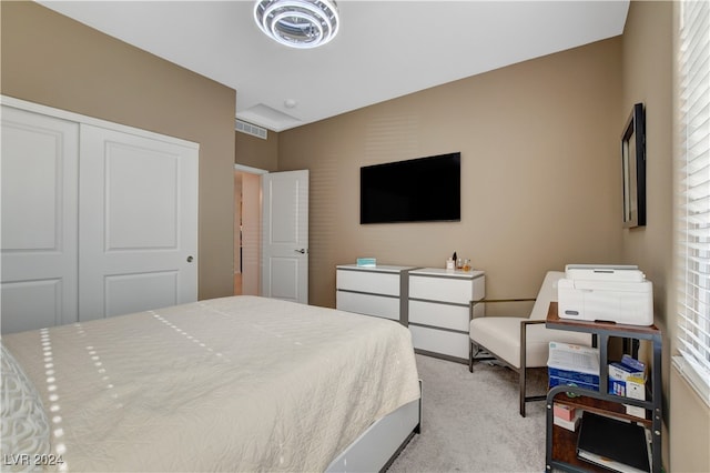 bedroom featuring light carpet and a closet