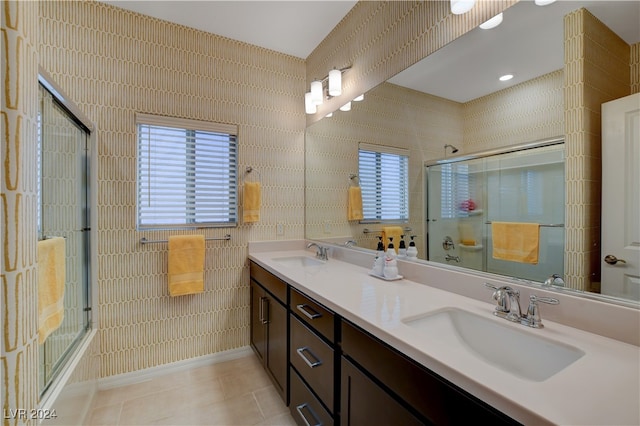 bathroom with tile patterned flooring, a wealth of natural light, vanity, and tile walls